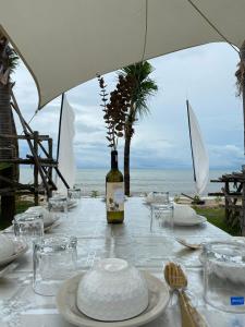a table with a bottle of wine and a cake on it at F&F Poolvilla Beach Tha Chana in Suratthani