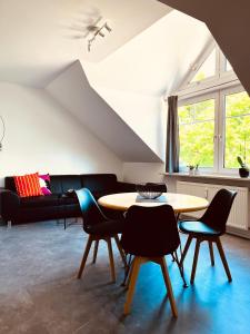 a living room with a table and chairs and a couch at Pension Lutter in Bodenwöhr
