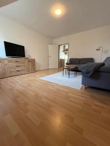 a living room with a couch and a flat screen tv at Ferienwohnung Meyer in Neuenkirchen