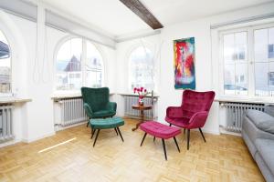 a living room with three chairs and a couch at Villa Primavera in Nesselwang +28 photos