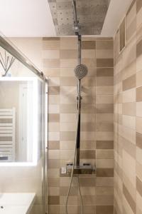 a bathroom with a shower with a shower head at FORMENTOR Apartment in Salou +28 photos