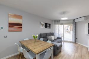a living room with a table and a couch at FORMENTOR Apartment in Salou