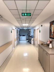 an empty hallway in an hospital with a clock on the ceiling at mutlu genç dur in Atakum