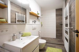 a bathroom with a white sink and a toilet at Bergliebe in Nesselwang