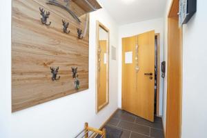 a hallway with a wooden wall with animal heads on it at Bergliebe in Nesselwang +1 photo