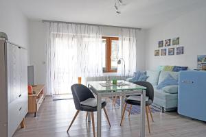 a living room with a table and chairs and a couch at Am Mühlbach in Nesselwang