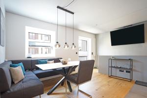 a living room with a couch and a table at Exclusive Maisonettewohnung! in Nesselwang