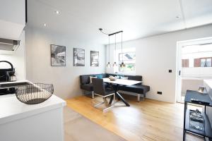 a kitchen and dining room with a table and chairs at Exclusive Maisonettewohnung! in Nesselwang