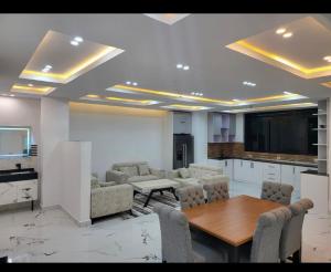a living room with a table and chairs and a kitchen at Ethiopian dream in Addis Ababa