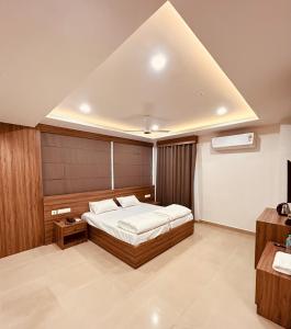 a bedroom with a bed in a room with at MALAPPURAM RESIDENCY in Malappuram