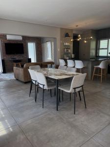 a dining room and living room with a table and chairs at Villa Bella in George