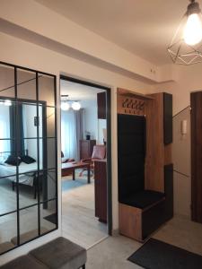 a living room with a sliding glass door leading to a bedroom at Apartament SIEDEMNAŚCIE in Sanok