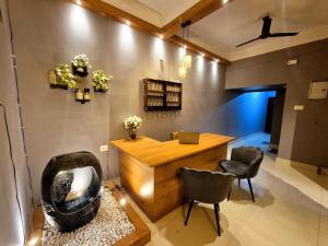 a room with a desk and chairs in a room at Luxe Haven Homestay 2A in Guwahati