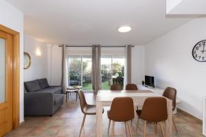 a living room with a table and chairs and a couch at Cumbre in Salou +39 photos