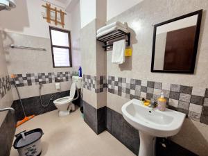 a bathroom with a sink and a toilet at Luxe Haven Homestay 2A in Guwahati