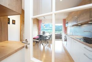 a kitchen with a table and a dining room at Panoramaweg in Wertach