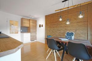 a kitchen and dining room with a table and chairs at Panoramaweg in Wertach +15 photos