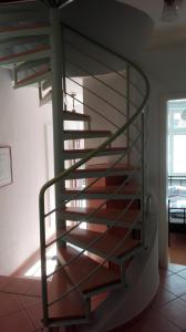 a metal spiral staircase in a living room at Ferienhaus Wismar in Wismar