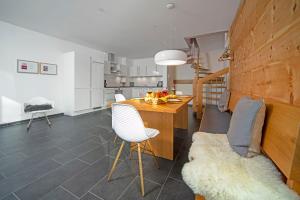 a kitchen and dining room with a table and chairs at Chalet am Breitenberg Apt1 in Pfronten