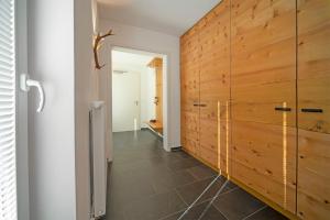 a hallway with a wooden wall and a door at Chalet am Breitenberg Apt1 in Pfronten