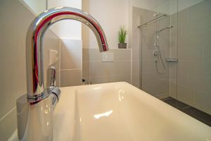 a sink with a faucet in a bathroom at Chalet am Breitenberg Apt1 in Pfronten +14 photos