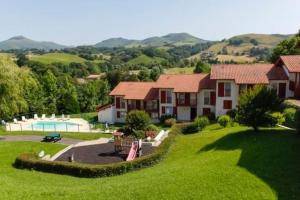a house on a green hill with a swimming pool at B4 Vue Montagnes Piscine in Souraïde