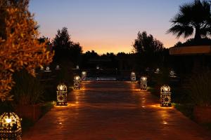 a pathway with lights in a garden at sunset at Maison d'Hôtes Errafiqi in Safi