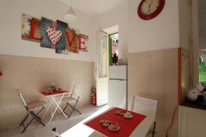 a kitchen with a table and a white refrigerator at Lido di Ostia 1933 in Lido di Ostia