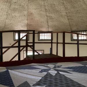 an empty room with windows and a tiled floor at Tida-Ecolodge in Kartung