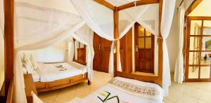 a bedroom with two beds in a room at Villa Nirwana in Lovina +30 photos