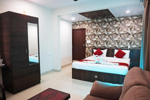 a hotel room with a bed and a mirror at Hotel Fortune 36 in Bangalore