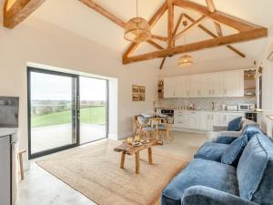 a living room with a blue couch and a table at 2 Bed in Bromyard oc-91816 in Collington