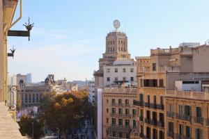 a tall building with a clock tower on top of it at Hamilton Suites in Barcelona