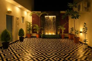 a lobby with potted plants and a fountain at Casa37 in Jaipur