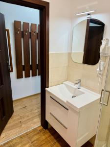 a bathroom with a white sink and a mirror at Willa u Marioli in Ściegny +41 photos