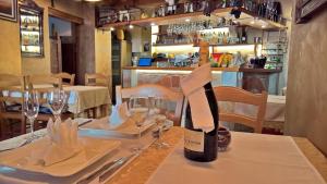 a table with glasses and a bottle of wine on it at Boutique Hotel Melissa in Poreč