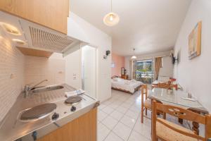 a kitchen with a sink and a living room at Myros Studios in Argostoli +25 photos