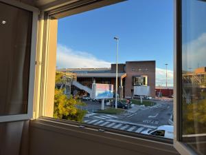 a window with a view of a city street at OTB ITALIA - Airport Rooms in Treviso