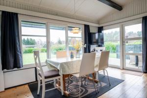 a dining room with a table and chairs at M252-Vaeggerlose-Bjergfruevej-6 in Bøtø By