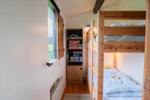 a bedroom with two bunk beds and a window at M252-Vaeggerlose-Bjergfruevej-6 in Bøtø By