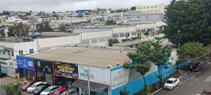 an overhead view of a city with cars parked in a parking lot at Gutemberg Palace Hotel in Nova Serrana