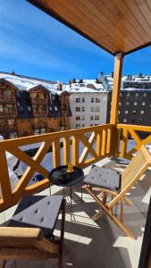 a balcony with a table and chairs on a building at Apartment Vučko Lux C334 Private host in Jahorina