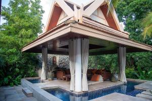 a pavilion with a pool in front of a house at Baan Na Villa in Satuk