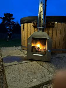 a fireplace sitting on the sidewalk in a yard at Finest Retreats - The Flower Hut in Charlton