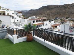 a balcony with a view of a city at Stunning Ocean Views in Puerto de Mogan in Puerto de Mogán