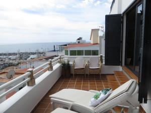 a balcony with chairs and a view of the ocean at Stunning Ocean Views in Puerto de Mogan in Puerto de Mogán +16 photos