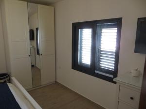a room with a window and a bedroom with a mirror at Stunning Ocean Views in Puerto de Mogan in Puerto de Mogán