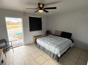 a bedroom with a bed and a flat screen tv at Cozy Cove inn in Saint Cloud