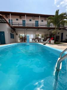 a large swimming pool in front of a house at Pousada Amarílis in Barra de Santo Antônio