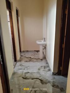 a bathroom with a white sink in a room at Luxury Homes in Mtwapa +1 photo